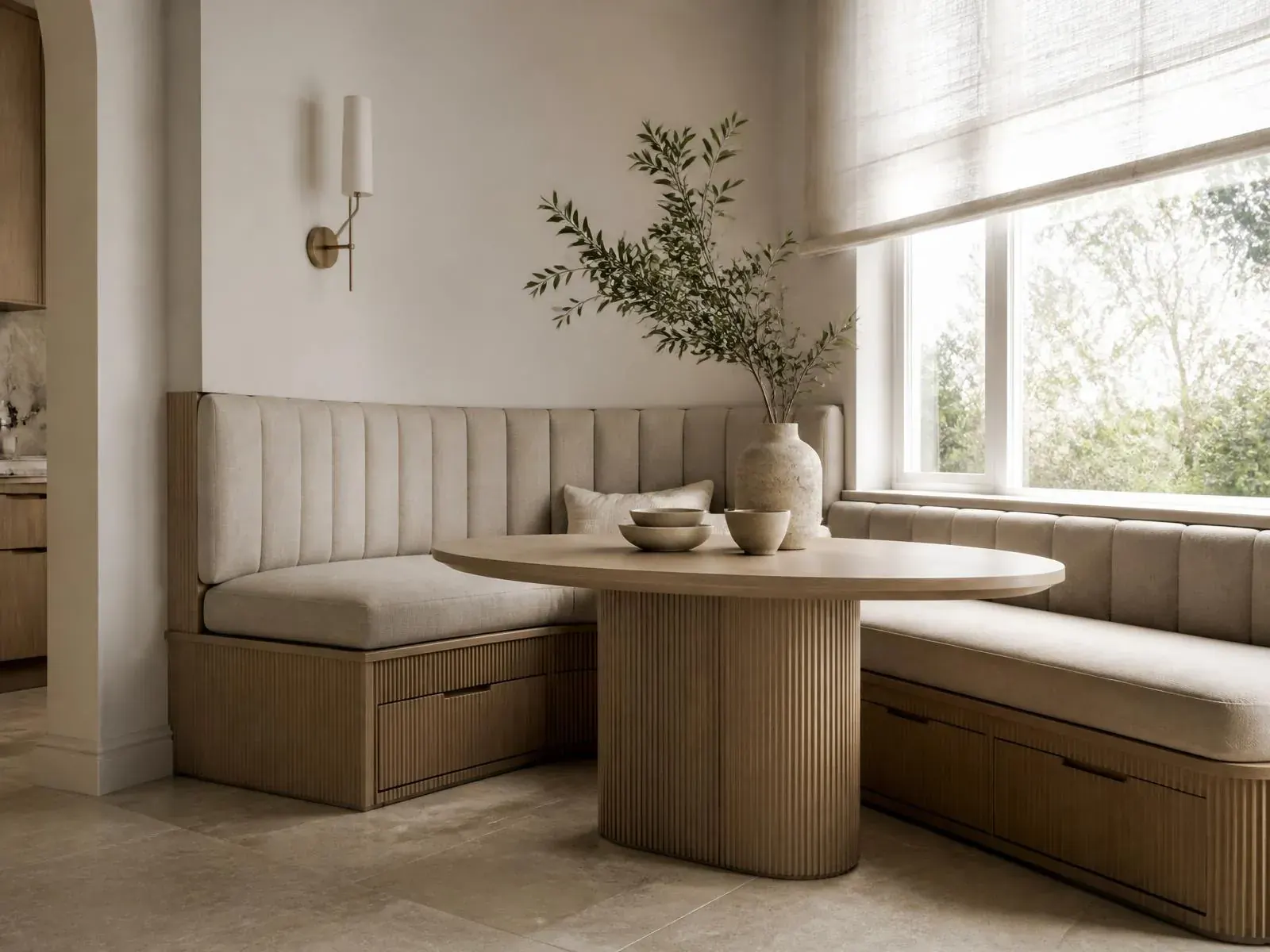 Custom built-in breakfast nook with bench seating, integrated storage, and fluted detailing